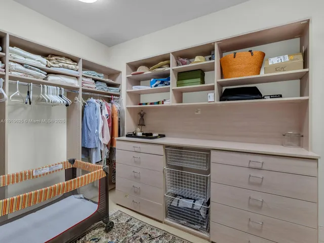 a bedroom with a bed and a lamp on dresser