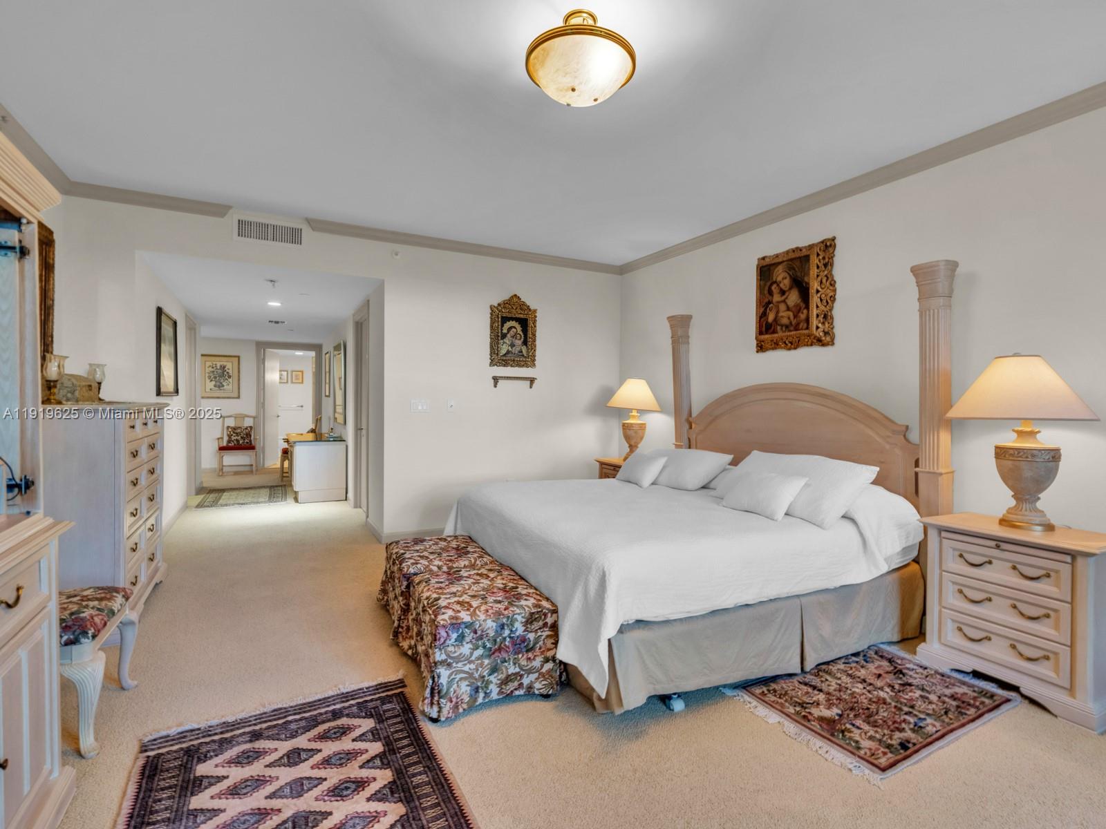 445 Grand Bay Drive, Unit 303 Key Biscayne, FL 33149 - Photo 34 of 52 a bedroom with a bed and a lamp on dresser