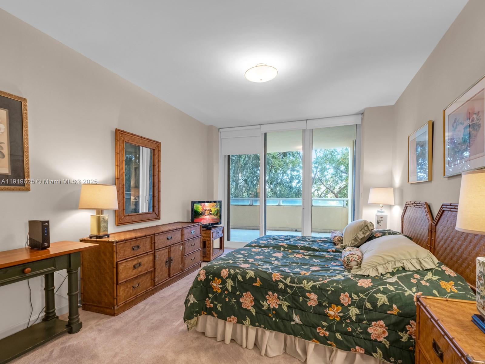 445 Grand Bay Drive, Unit 303 Key Biscayne, FL 33149 - Photo 40 of 52 a bed sitting in a bedroom next to a window