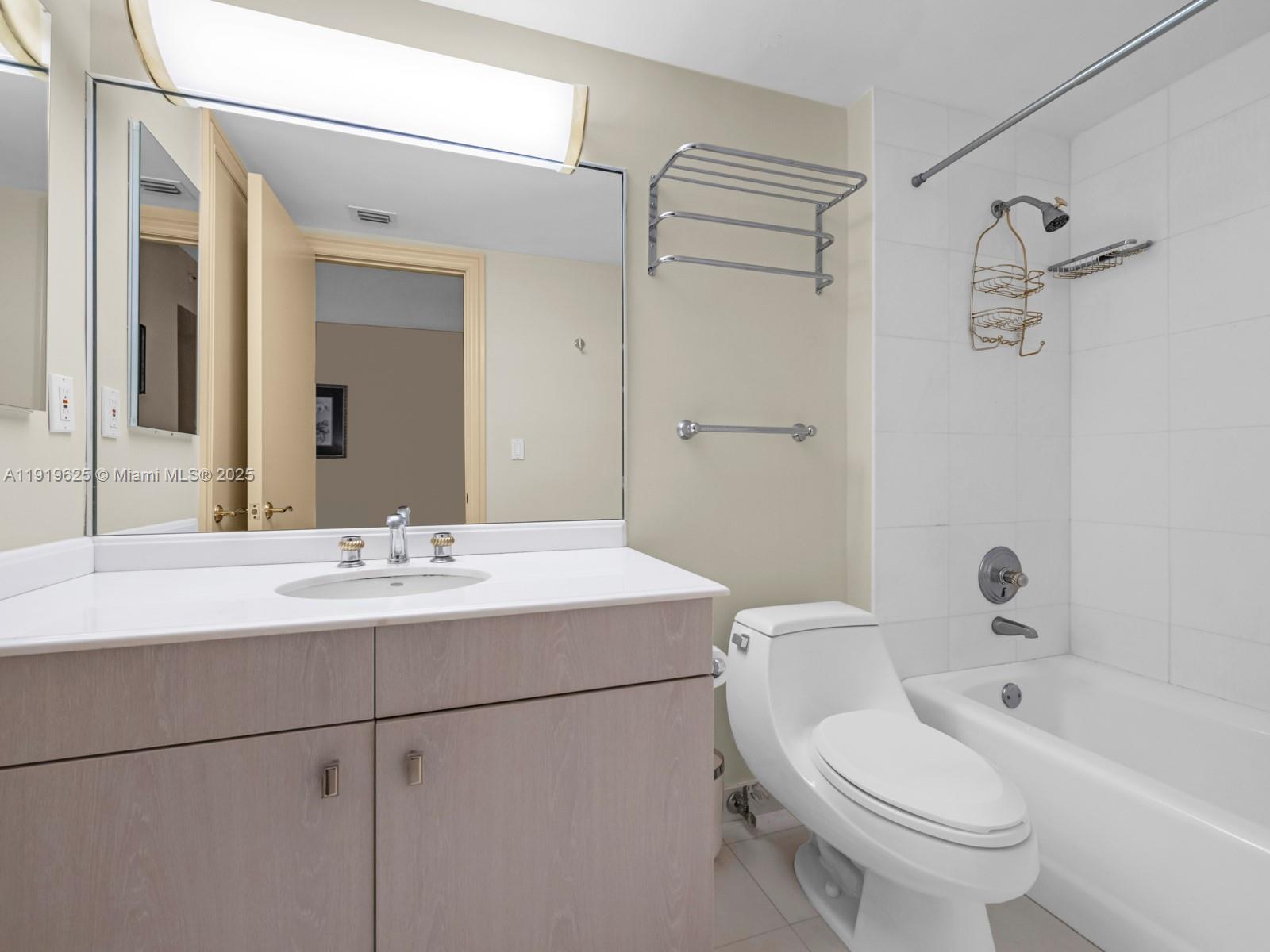 445 Grand Bay Drive, Unit 303 Key Biscayne, FL 33149 - Photo 41 of 52 a bathroom with a sink toilet and shower