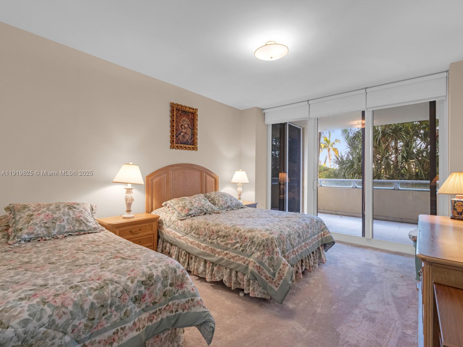 445 Grand Bay Drive, Unit 303 Key Biscayne, FL 33149 - Photo 42 of 52 a bedroom with two large bed and a large window