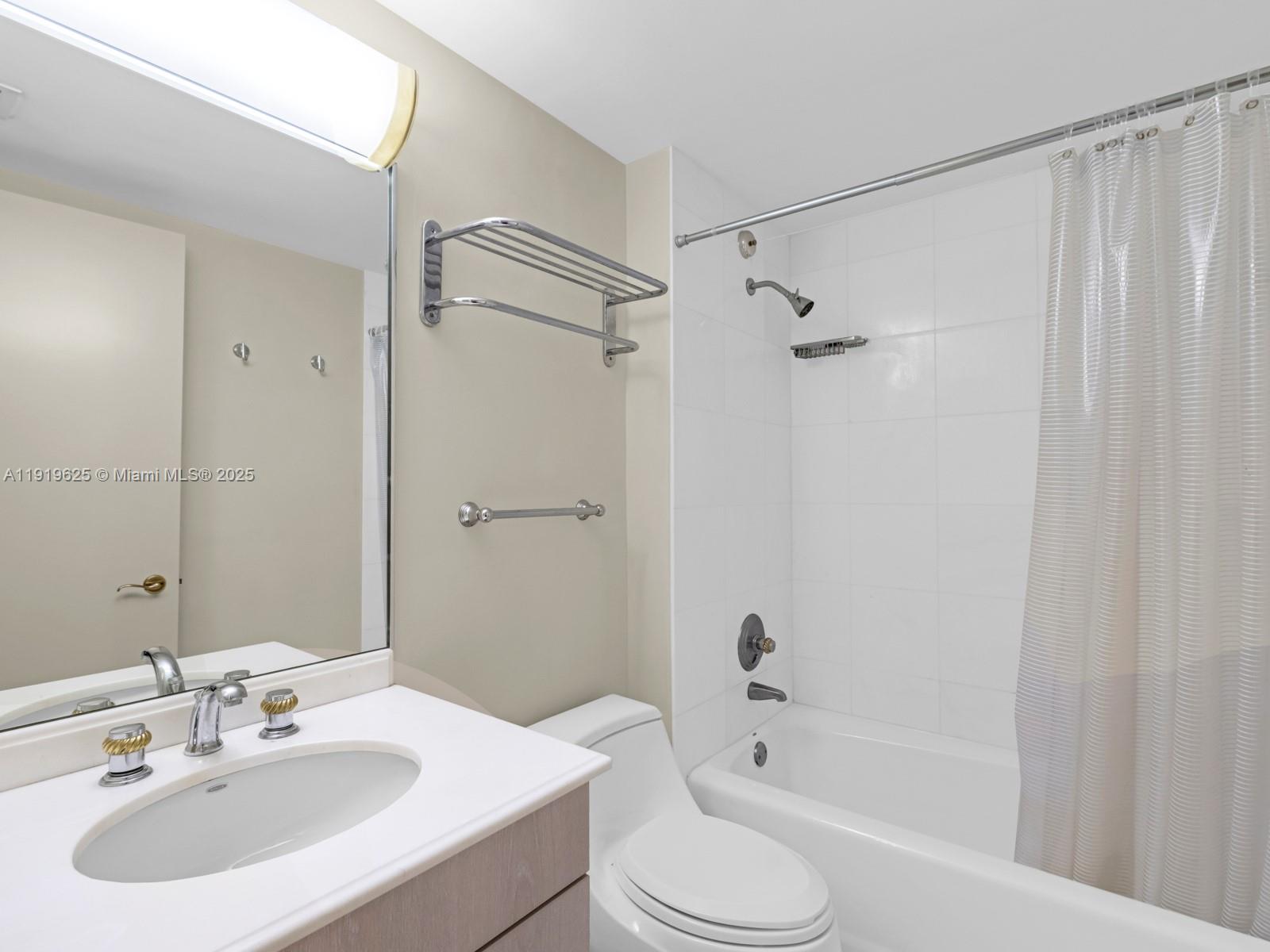 445 Grand Bay Drive, Unit 303 Key Biscayne, FL 33149 - Photo 43 of 52 a bathroom with a sink toilet and shower
