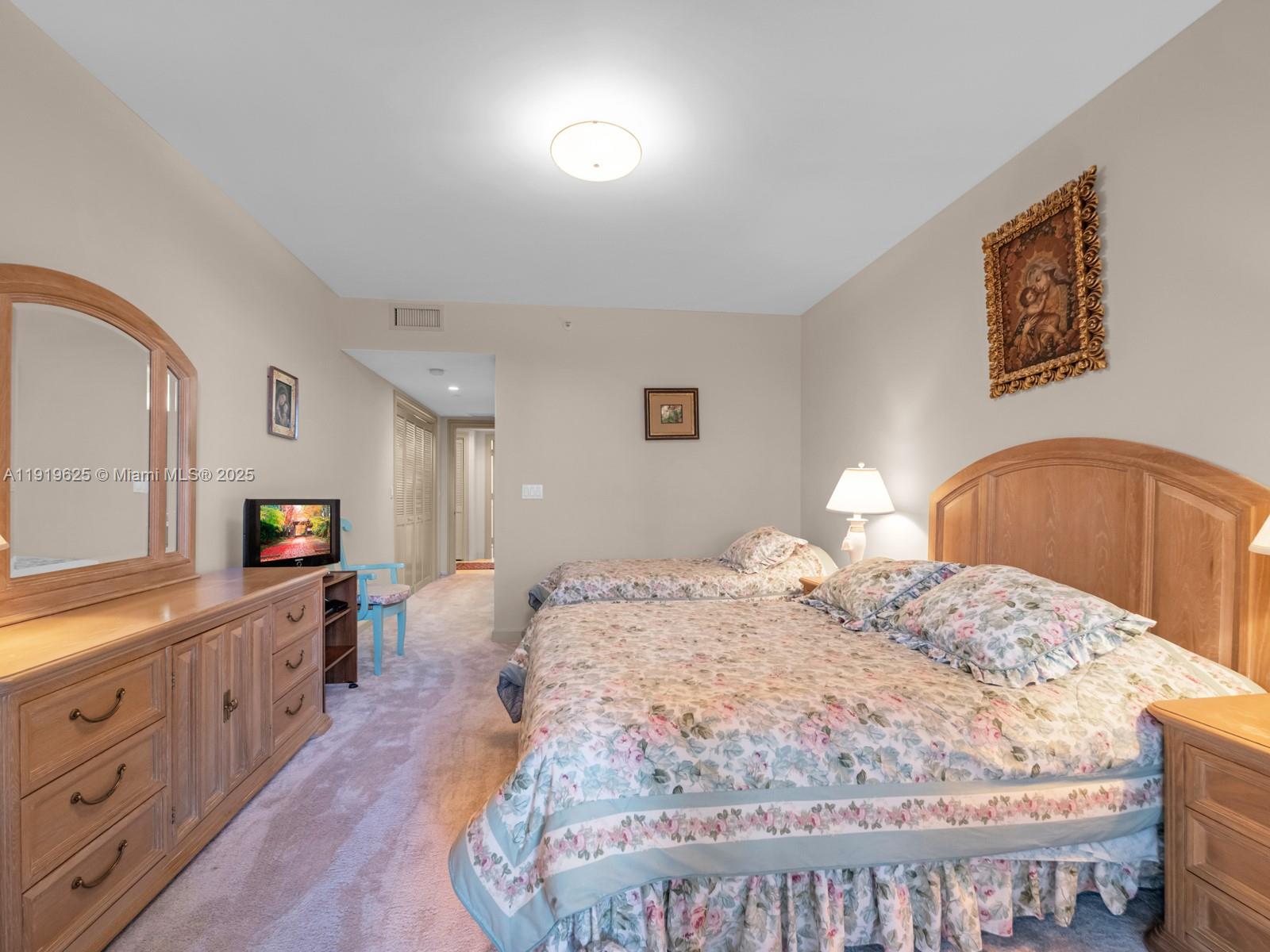 445 Grand Bay Drive, Unit 303 Key Biscayne, FL 33149 - Photo 44 of 52 a bed sitting in a bedroom and dresser