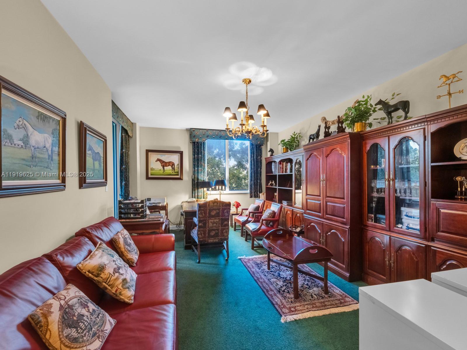 445 Grand Bay Drive, Unit 303 Key Biscayne, FL 33149 - Photo 46 of 52 a living room with furniture a chandelier and a dining table