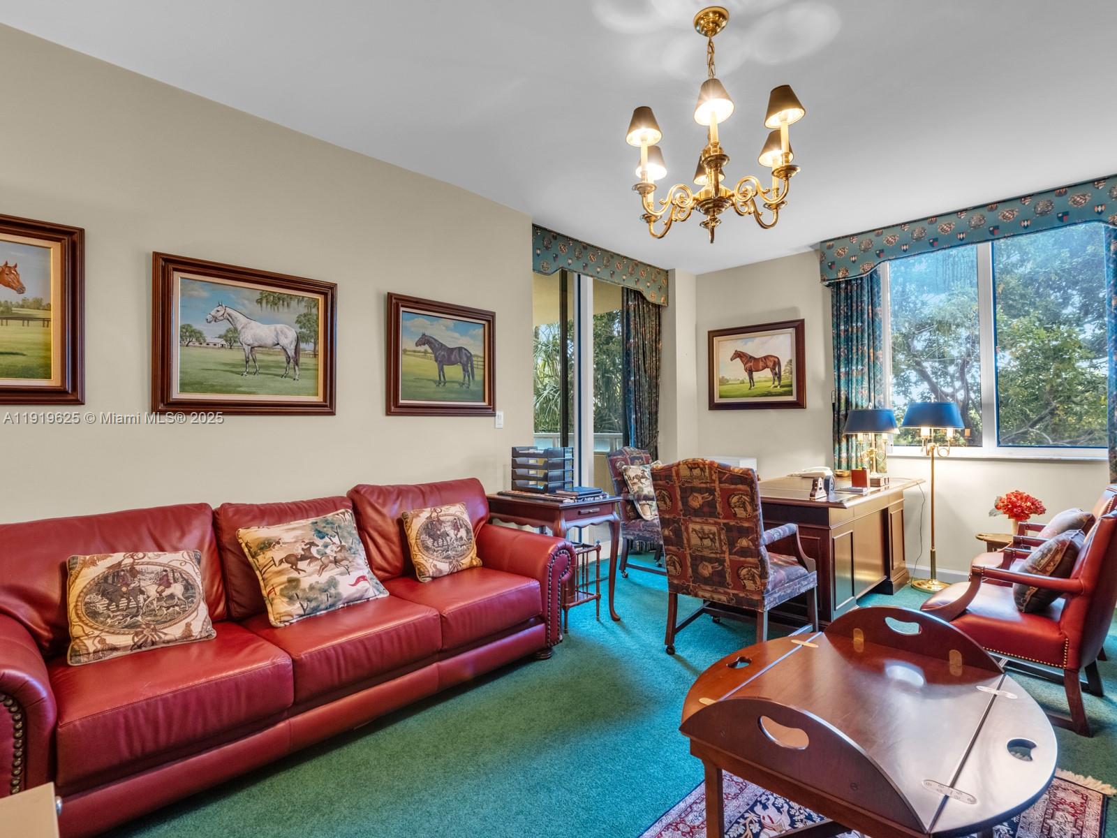 445 Grand Bay Drive, Unit 303 Key Biscayne, FL 33149 - Photo 47 of 52 a living room with furniture a chandelier and a window