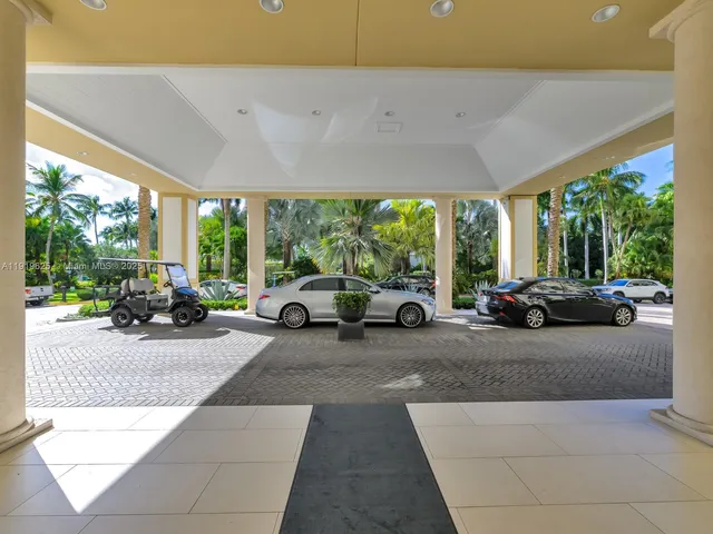 a view of a patio with table and chairs in front of a yard