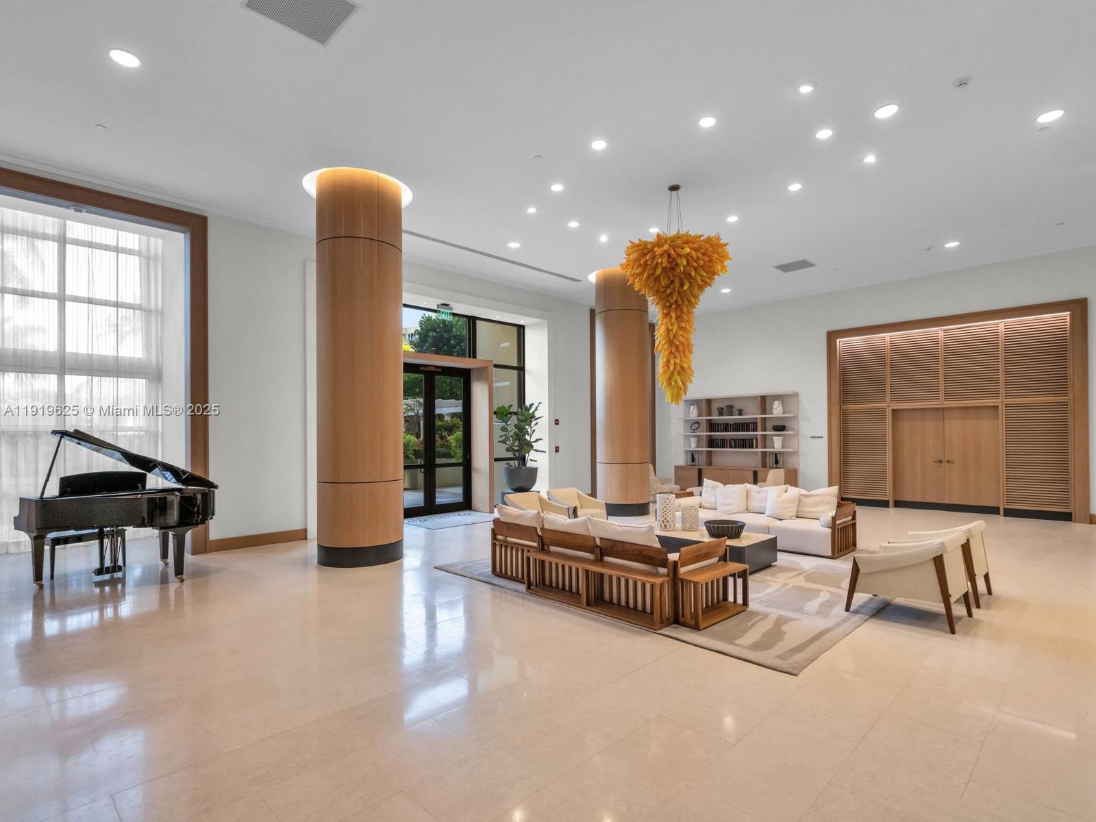 445 Grand Bay Drive, Unit 303 Key Biscayne, FL 33149 - Photo 9 of 52 a living room with furniture and a large window