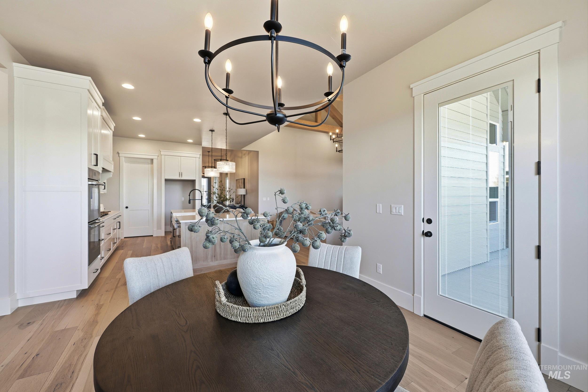 6771 South Messner Way Meridian, ID 83642 - Photo 11 of 45 Dining area with light wood-style floors, recessed lighting, and a chandelier