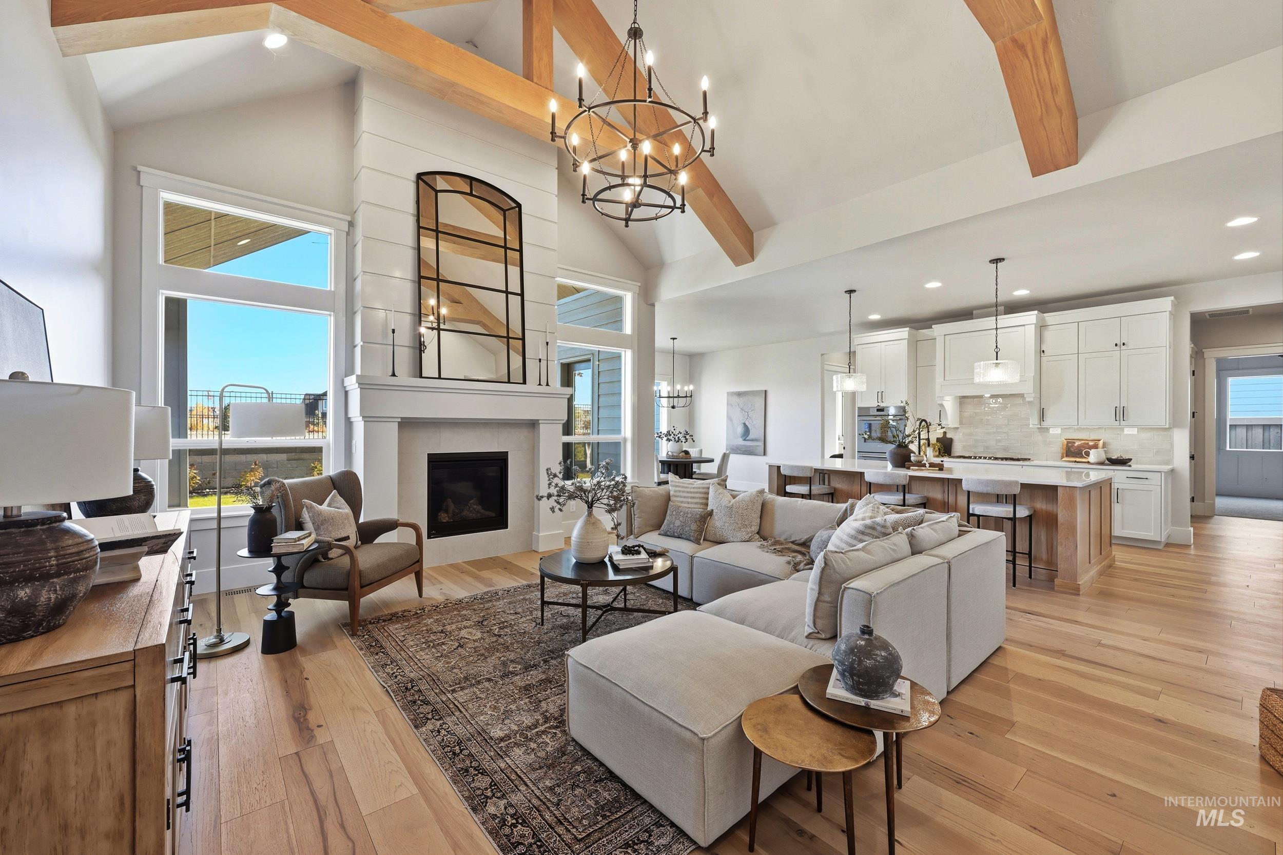 6771 South Messner Way Meridian, ID 83642 - Photo 6 of 45 Living room with beamed ceiling, a chandelier, light wood finished floors, high vaulted ceiling, and recessed lighting
