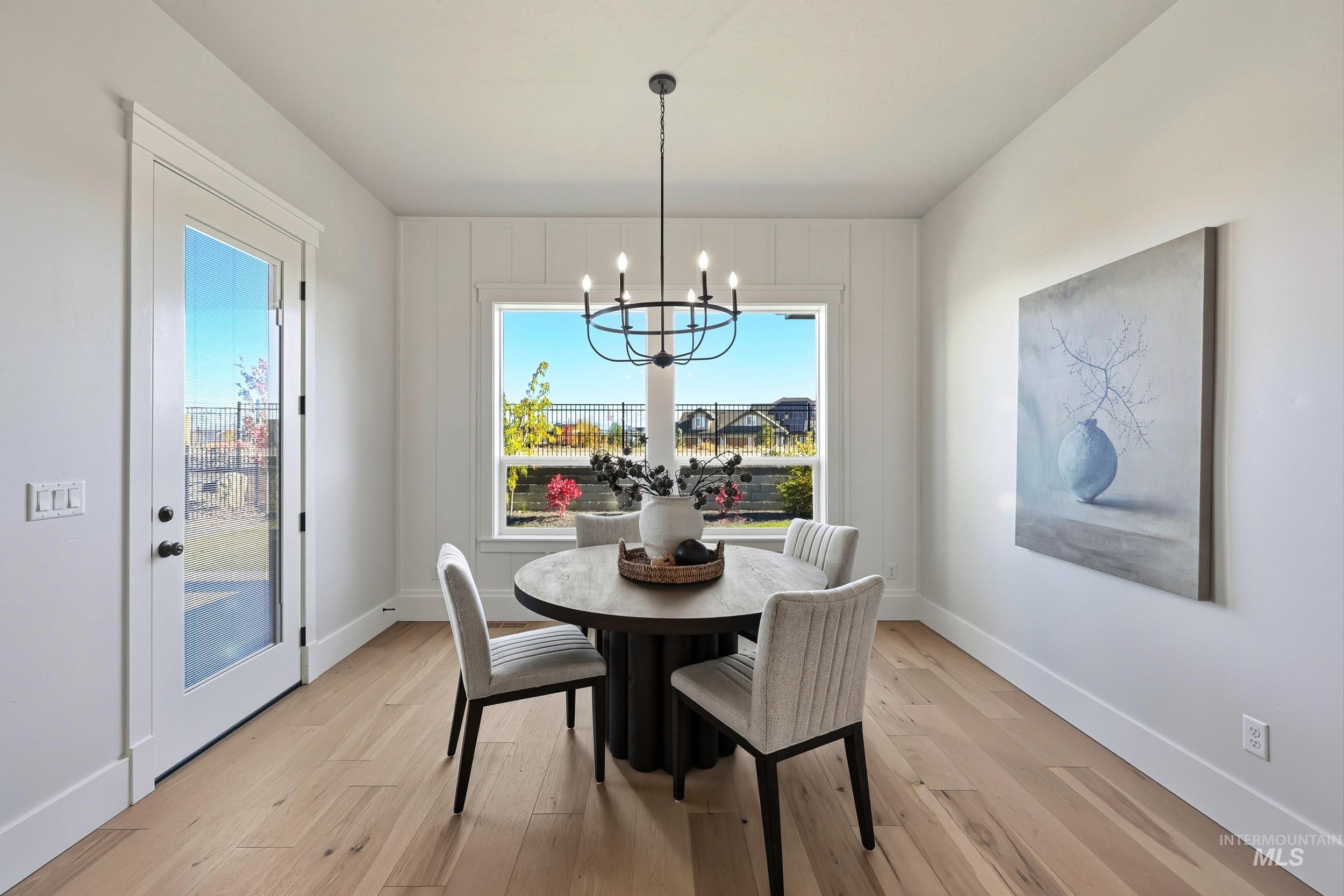 6771 South Messner Way Meridian, ID 83642 - Photo 10 of 45 Dining room featuring light wood-type flooring and a chandelier