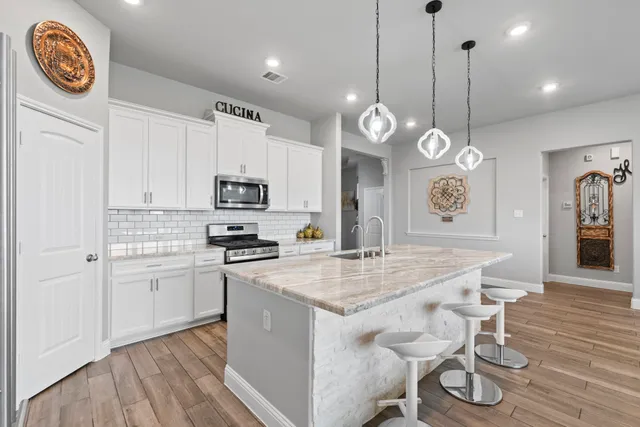 an open kitchen with a table and chairs in it