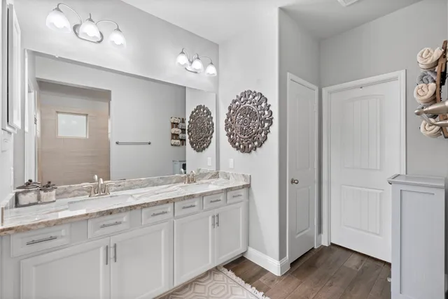 a bathroom with a granite countertop sink and a mirror