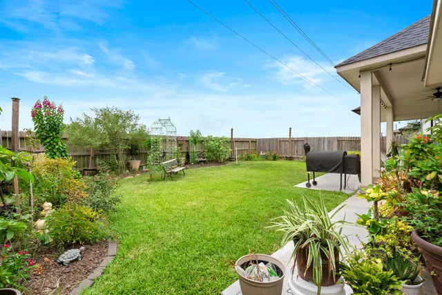 a view of a backyard with sitting area