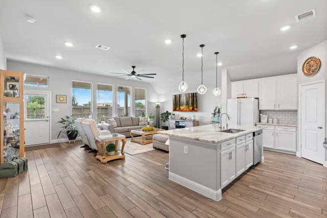 a open kitchen with stainless steel appliances granite countertop a lot of counter space and wooden floors