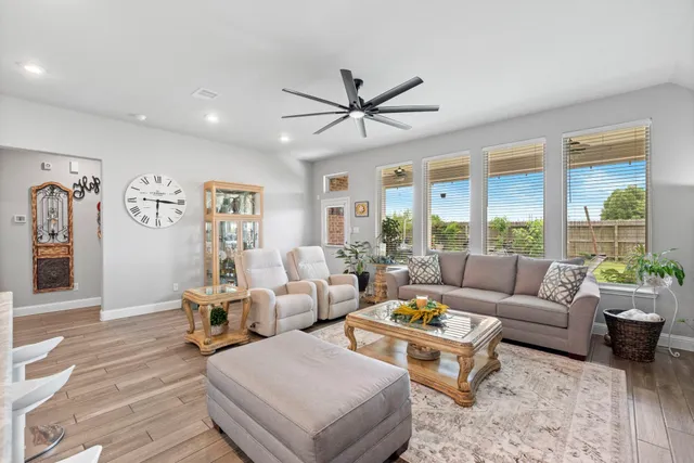 a living room with furniture and a large window