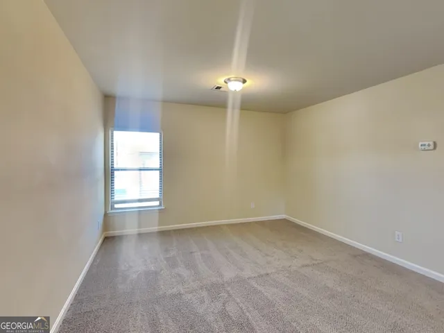 an empty room with a empty space and a window