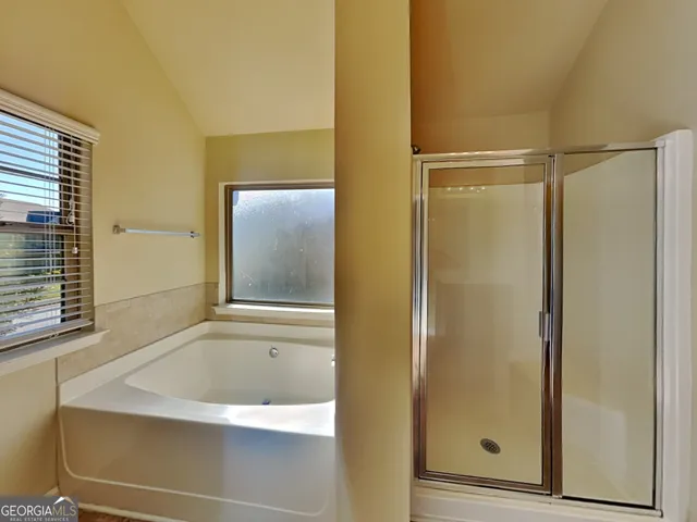 a bathroom with a bathtub and a shower