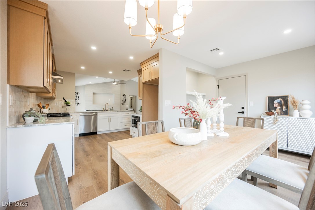 9337 Quail Ridge Drive Las Vegas, NV 89134 - Photo 15 of 28 Dining room with light wood-style floors, recessed lighting, and a chandelier