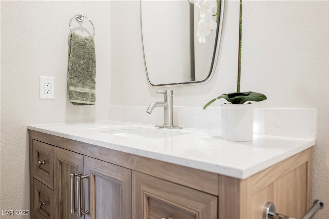 9337 Quail Ridge Drive Las Vegas, NV 89134 - Photo 9 of 28 Bathroom with vanity and a textured wall