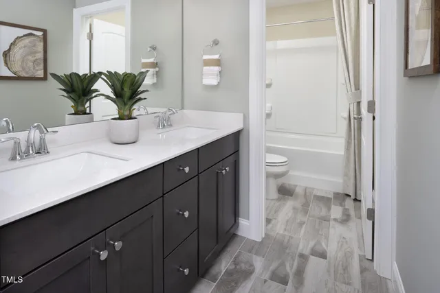 a bathroom with a granite countertop sink a toilet and with mirror