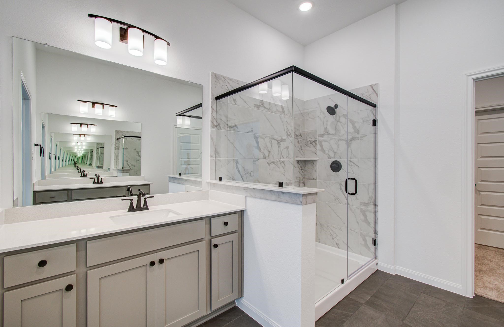 7231 Yarrow Blossom Court Katy, TX 77493 - Photo 3 of 49 a bathroom with a double vanity sink mirror and shower