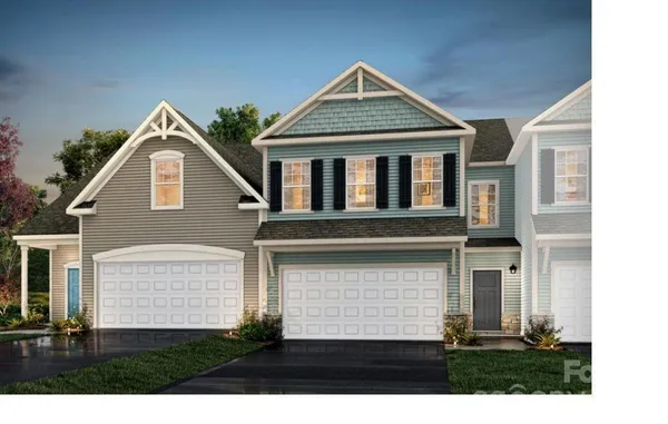 a view of house with yard and parking