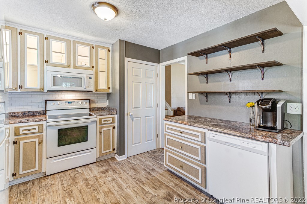 1435 Marlborough Road Fayetteville, NC 28304 - Photo 14 of 35 a kitchen with stainless steel appliances granite countertop a stove and a sink