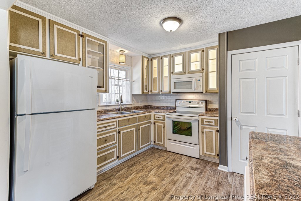 1435 Marlborough Road Fayetteville, NC 28304 - Photo 15 of 35 a kitchen with granite countertop a refrigerator stove and sink
