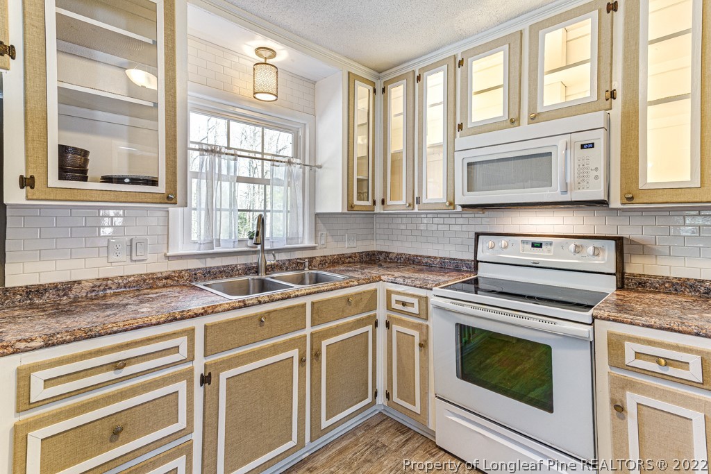 1435 Marlborough Road Fayetteville, NC 28304 - Photo 16 of 35 a kitchen with stainless steel appliances granite countertop white cabinets and a window