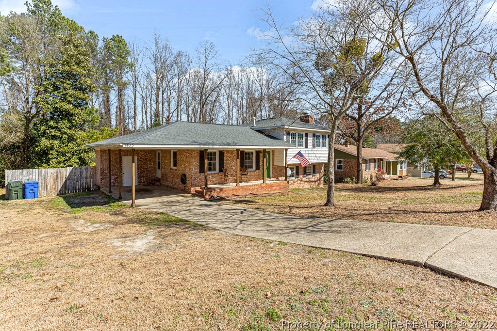 1435 Marlborough Road Fayetteville, NC 28304 - Photo 2 of 35 a backyard of a house with large trees and barbeque oven