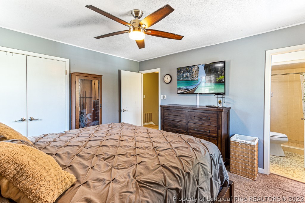 1435 Marlborough Road Fayetteville, NC 28304 - Photo 24 of 35 a bedroom with a bed and a dresser