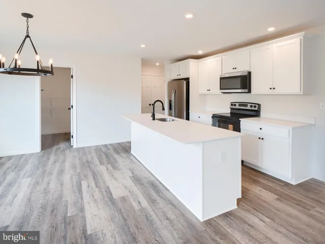 a kitchen with granite countertop a sink and steel appliances