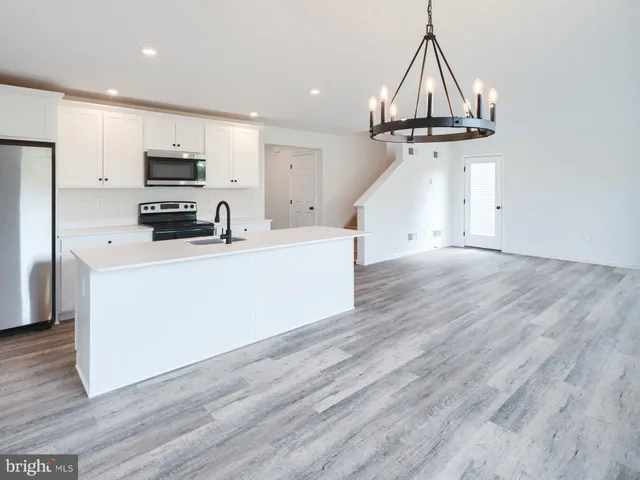 a kitchen with a sink stainless steel appliances and cabinets