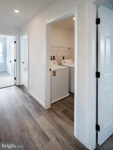 a view of a hallway with closet and wooden floor