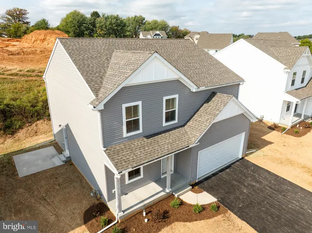 a view of house with roof deck and living room