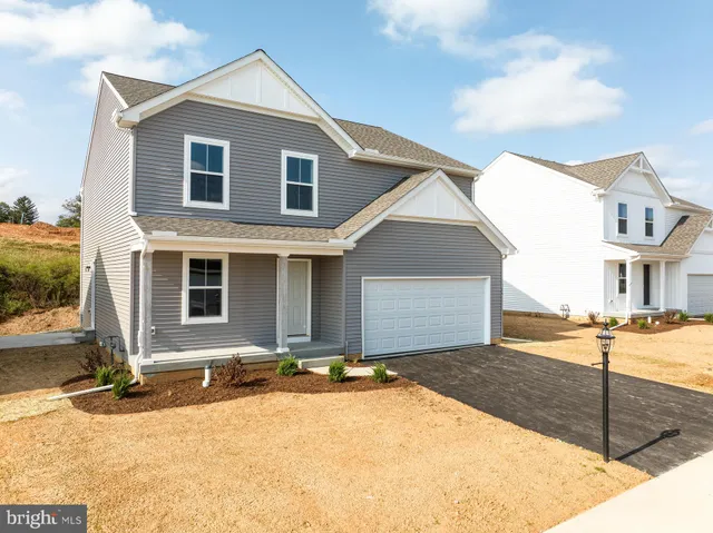 a view of a house with snow on the road