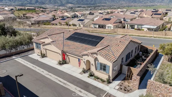 an aerial view of multiple houses with a yard