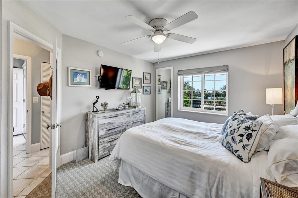 5854 Gasparilla Road, Unit M22 Boca Grande, FL 33921 - Photo 13 of 54 a bedroom with a bed and a flat screen tv