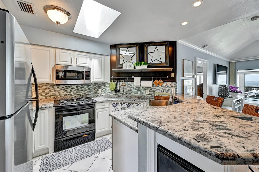 5854 Gasparilla Road, Unit M22 Boca Grande, FL 33921 - Photo 14 of 54 a kitchen with a stove and a sink