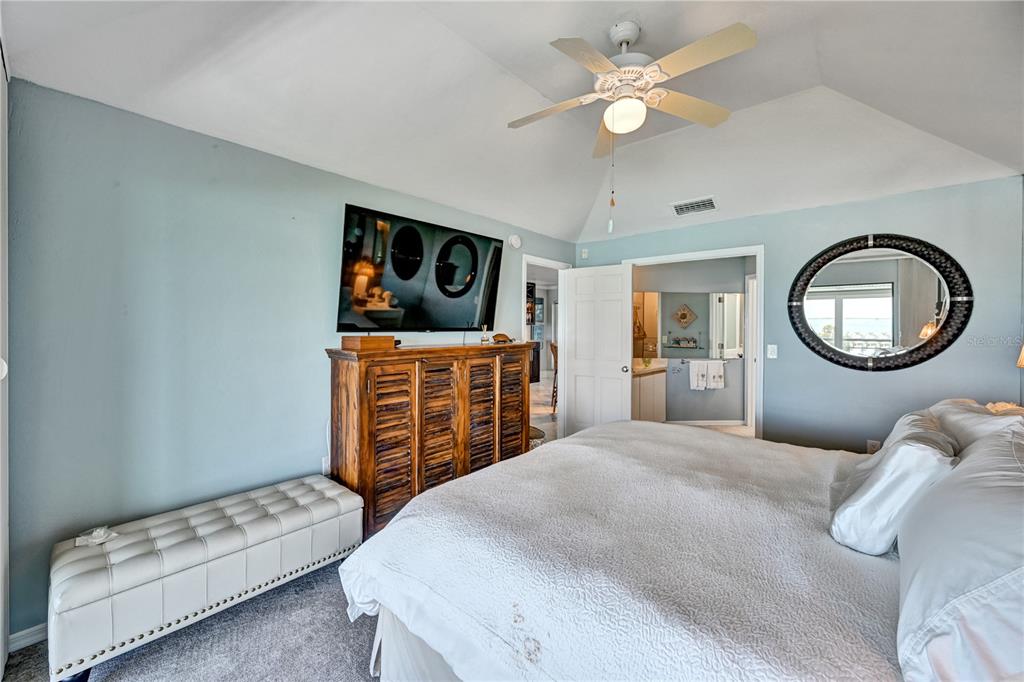 5854 Gasparilla Road, Unit M22 Boca Grande, FL 33921 - Photo 17 of 54 a bedroom with furniture and a mirror