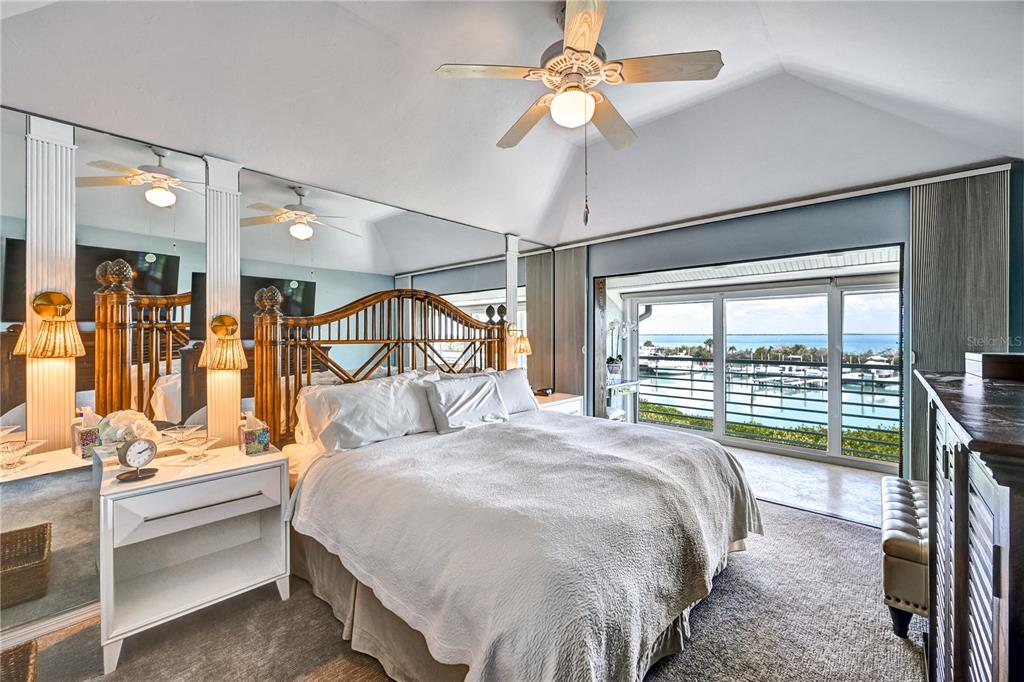 5854 Gasparilla Road, Unit M22 Boca Grande, FL 33921 - Photo 22 of 54 a bed room with a bed and a chandelier