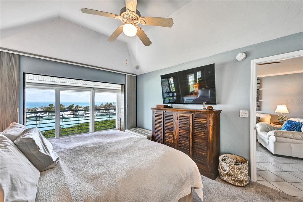 5854 Gasparilla Road, Unit M22 Boca Grande, FL 33921 - Photo 23 of 54 a bedroom with a bed and a large window with the outer view