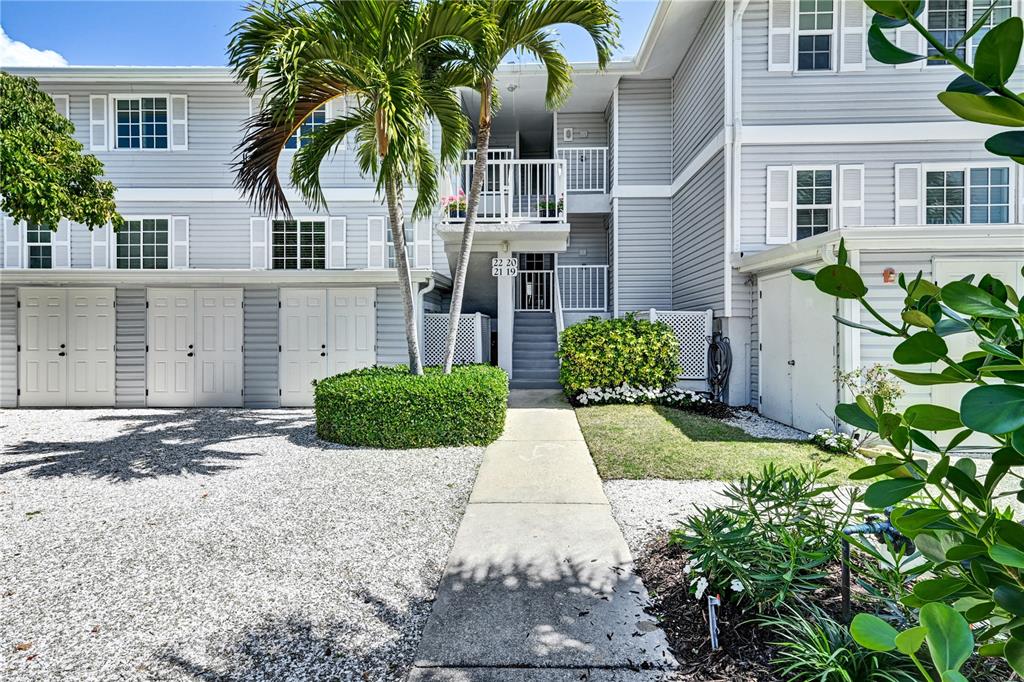 5854 Gasparilla Road, Unit M22 Boca Grande, FL 33921 - Photo 3 of 54 a front view of a house with garden