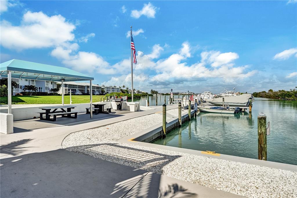 5854 Gasparilla Road, Unit M22 Boca Grande, FL 33921 - Photo 46 of 54 a swimming pool with outdoor seating and lake view