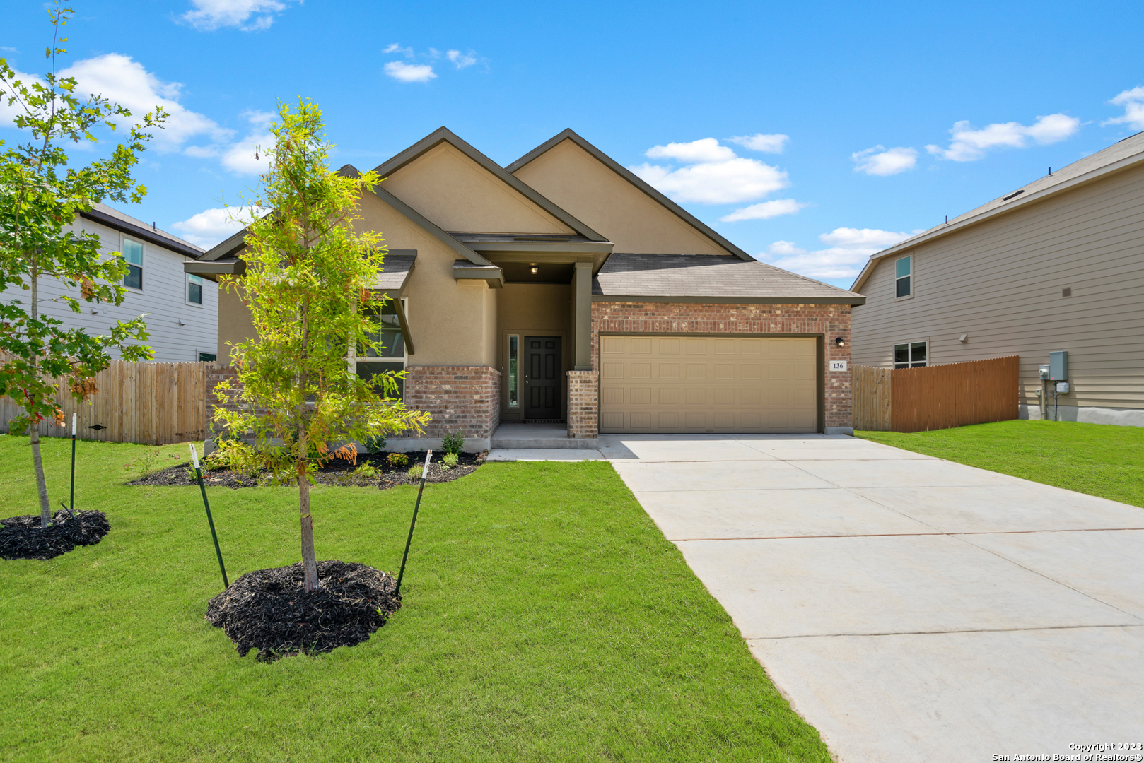 a front view of a house with a yard