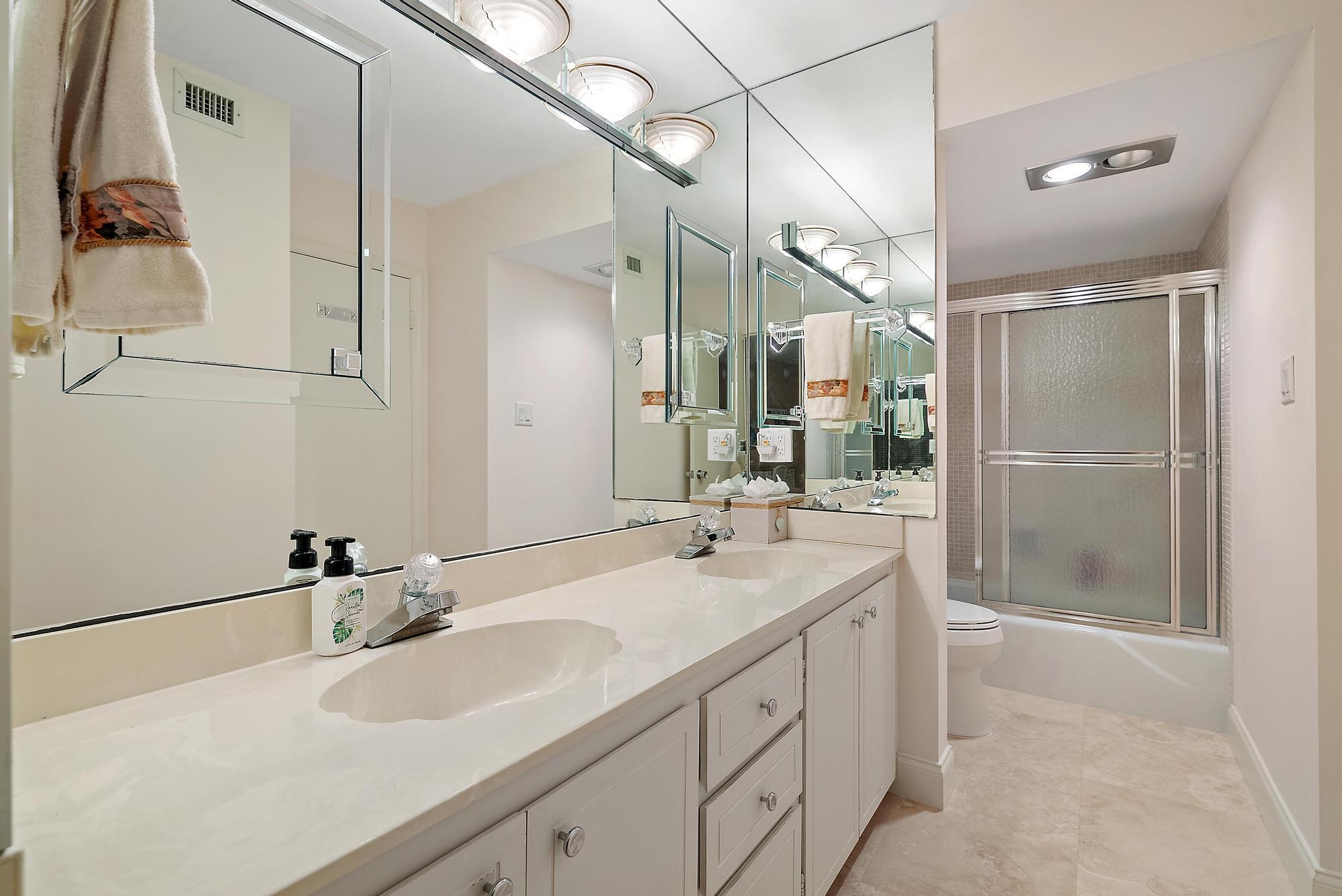 5380 North Ocean Drive, Unit 10B Singer Island, FL 33404 - Photo 17 of 50 a bathroom with a double vanity sink mirror and double