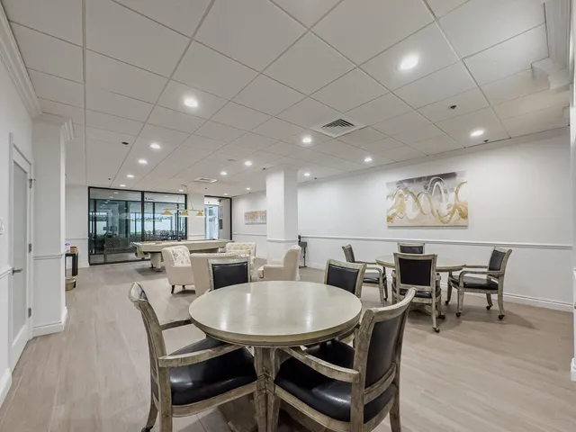 a view of a dining room with furniture wooden floor and chandelier