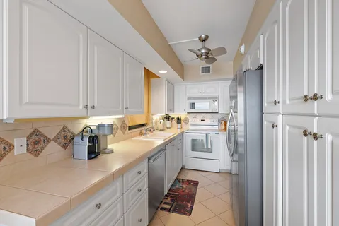 a kitchen with cabinets a sink and appliances