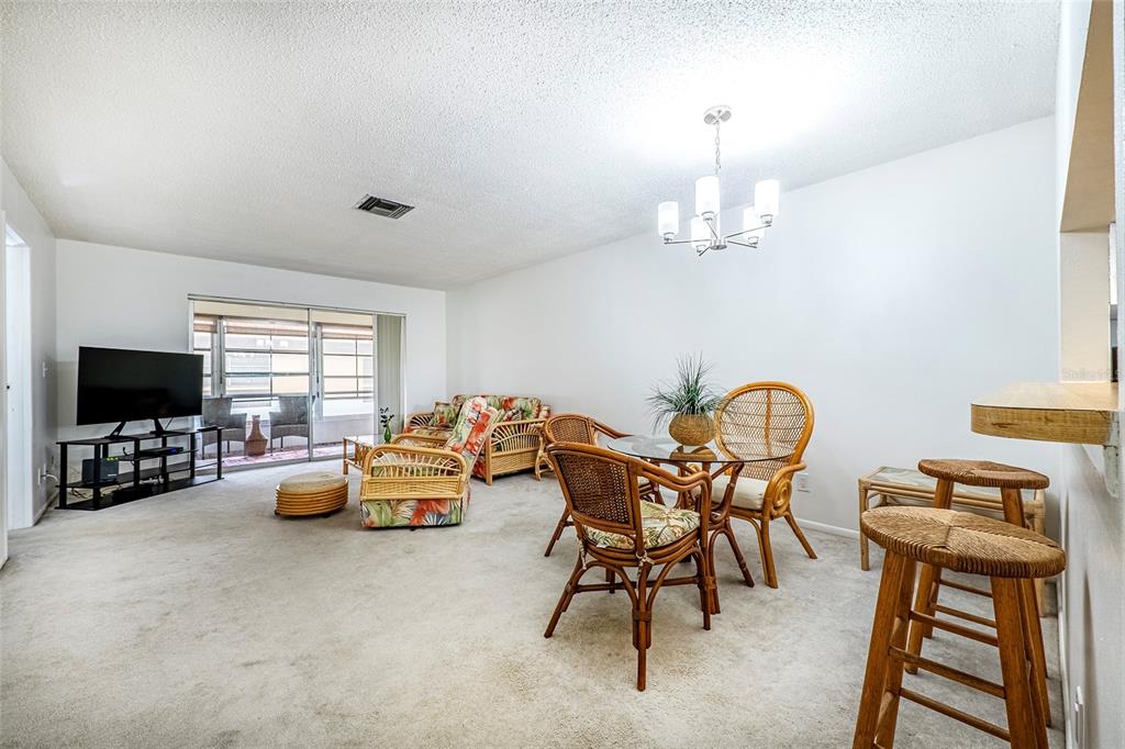 5197 Silent Loop, Unit 224 New Port Richey, FL 34652 - Photo 14 of 41 a bedroom with furniture and a flat screen tv