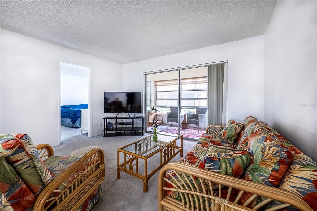5197 Silent Loop, Unit 224 New Port Richey, FL 34652 - Photo 15 of 41 a living room with furniture a flat screen tv and a window